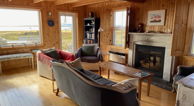 Living room with fireplace and view on the sea