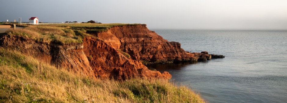 Red sandstone cliffs along the road Red sandstone cliff in the Magdalen Islands showing coastal erosion around the archipelago